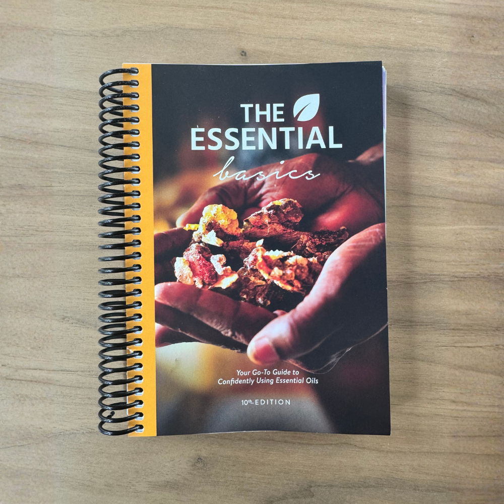 Book titled 'The Essential Basics' on a wooden surface